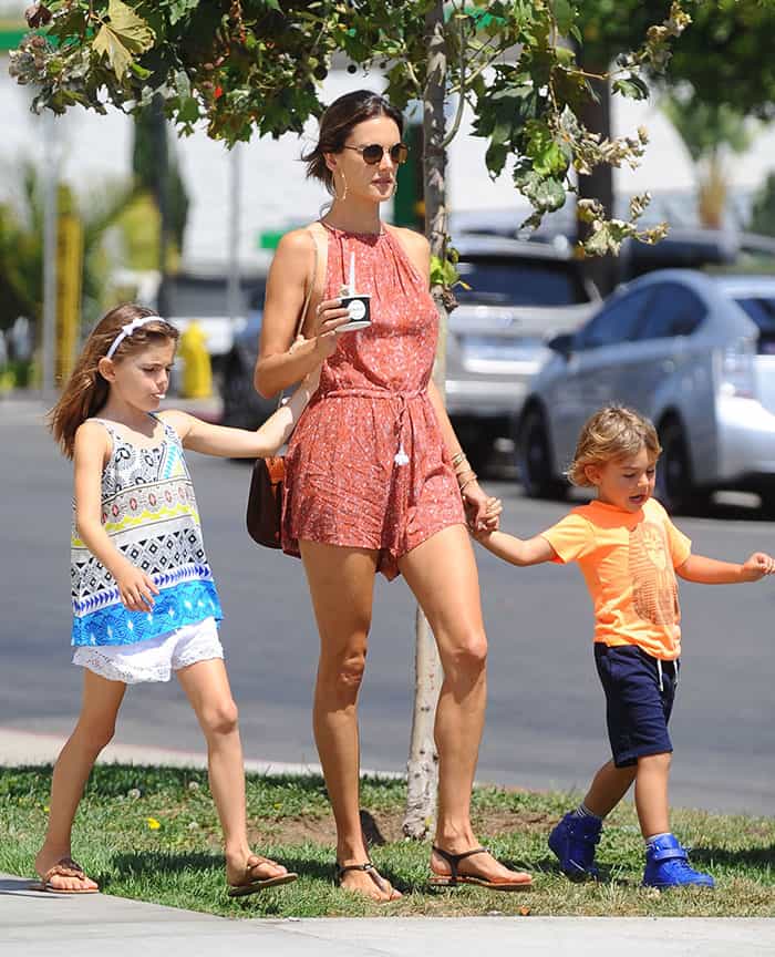 Alessandra Ambrosio slung a brown messenger bag over her shoulder