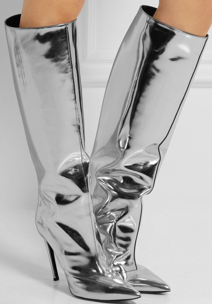 Inspired by couture archives, this statement boot is made from glossy silver mirrored leather and finished with a sleek pointed toe and pin-thin heel