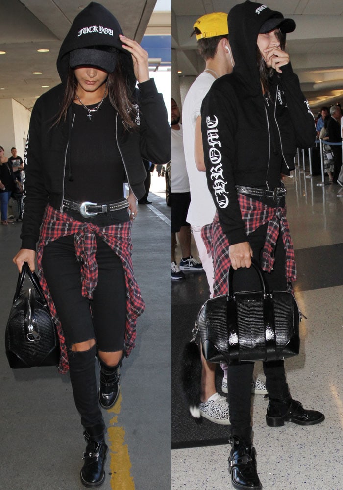 Bella Hadid leans into grunge-chic airport style, pairing James Jeans’ Black Swan Twiggy skinnies with a Chrome Hearts cropped hoodie, Hardware LDN velour cap, B-Low the Belt’s Barcelona belt, a Givenchy “Lucrezia” duffel, and her go-to Balenciaga “Ceinture” cutout boots