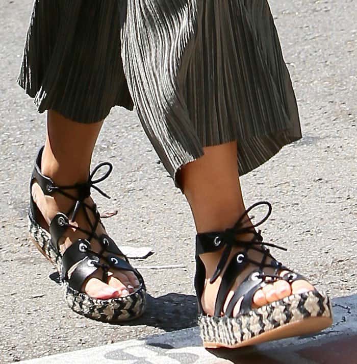Cara Santana steps out in Loeffler Randall lace-up espadrille sandals, featuring woven platform soles and sleek leather straps for a bold yet breezy summer look