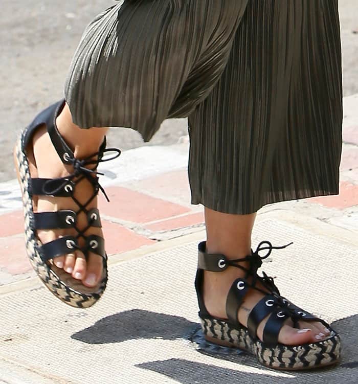 Cara Santana steps out in Loeffler Randall lace-up espadrille sandals, featuring woven platform soles and sleek leather straps for a bold yet breezy summer look
