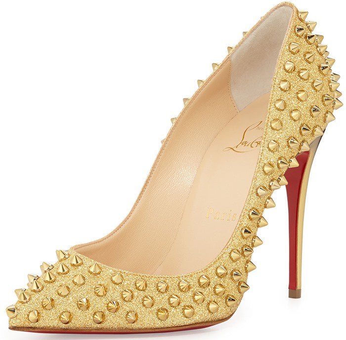 Christian Louboutin’s gold glitter “Follies Spikes” pumps feature an ultra-low vamp and all-over metallic studs for a high-impact take on the brand’s signature stiletto silhouette
