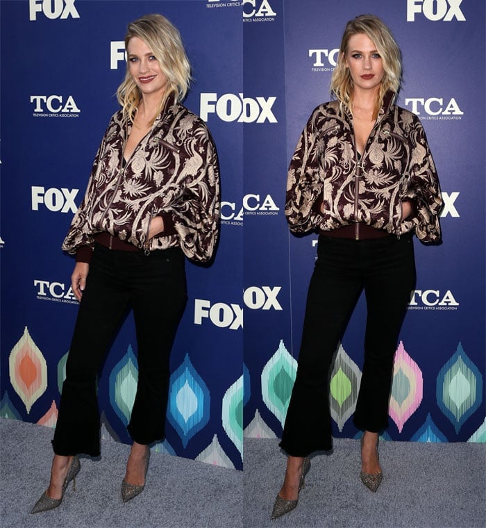 January Jones pairs a richly patterned bomber with cropped black pants, finishing the look with glittering pointed-toe pumps that add a refined, elongating contrast to the relaxed silhouette