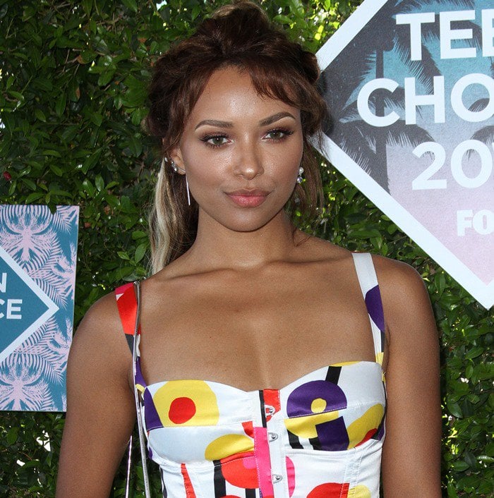 Kat Graham's printed, bustier-inspired Cavalli dress effortlessly captured the essence of the 80s with a modern twist, exuding an undeniable charm and nostalgia