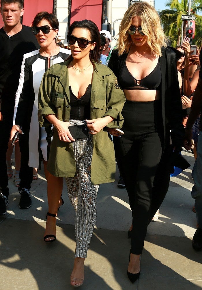 Kris Jenner, Kim Kardashian in sparkling Balmain pants, and Khloé Kardashian in a daring crop top all shield their eyes with oversized sunglasses while filming Keeping Up With the Kardashians in Beverly Hills