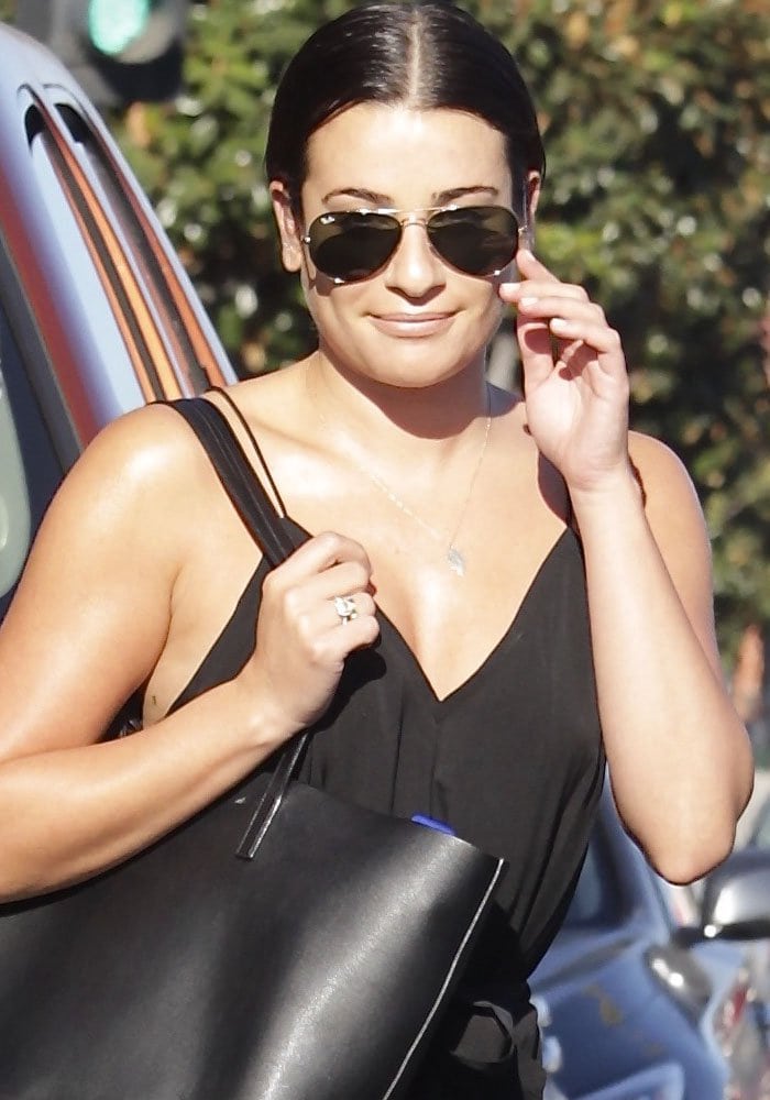 Lea Michele keeps it sleek and stylish with a black maxi dress, Ray-Ban aviators, and a Saint Laurent tote during her day out in West Hollywood