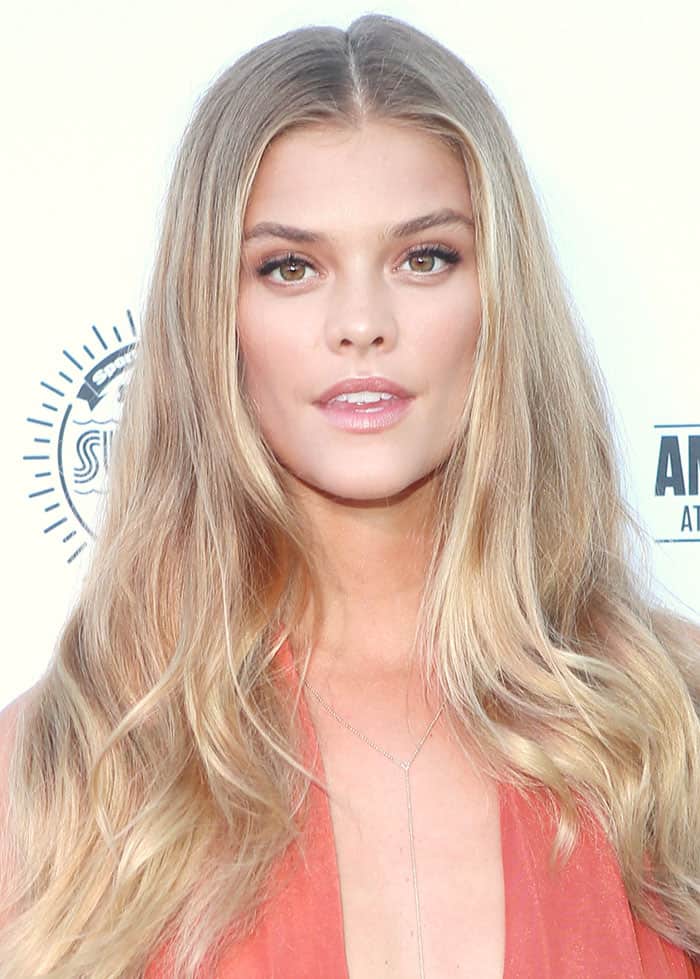 Nina Agdal's blonde locks flowed effortlessly down her shoulders in loose waves, perfectly complemented by a subtle makeup look