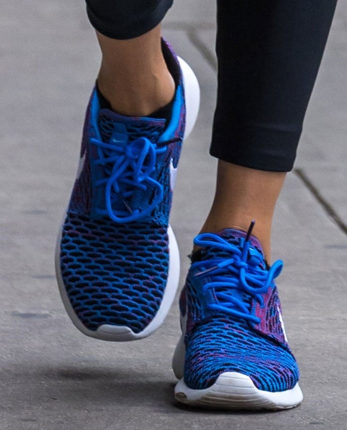 Olivia Palermo wears vibrant blue Nike Roshe One Flyknit sneakers with a unique mesh design and lightweight feel
