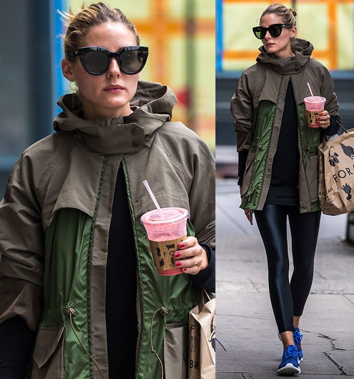 Olivia Palermo sports oversized sunglasses and a chic messy bun, sipping a pink smoothie while carrying a Foragers shopping bag on her casual New York City stroll