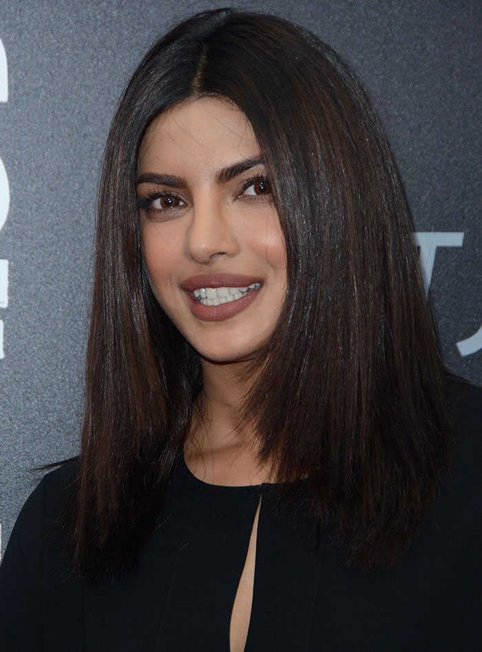 Priyanka Chopra wears her sleek dark hair center-parted with soft, natural makeup at the New York premiere of Hands of Stone