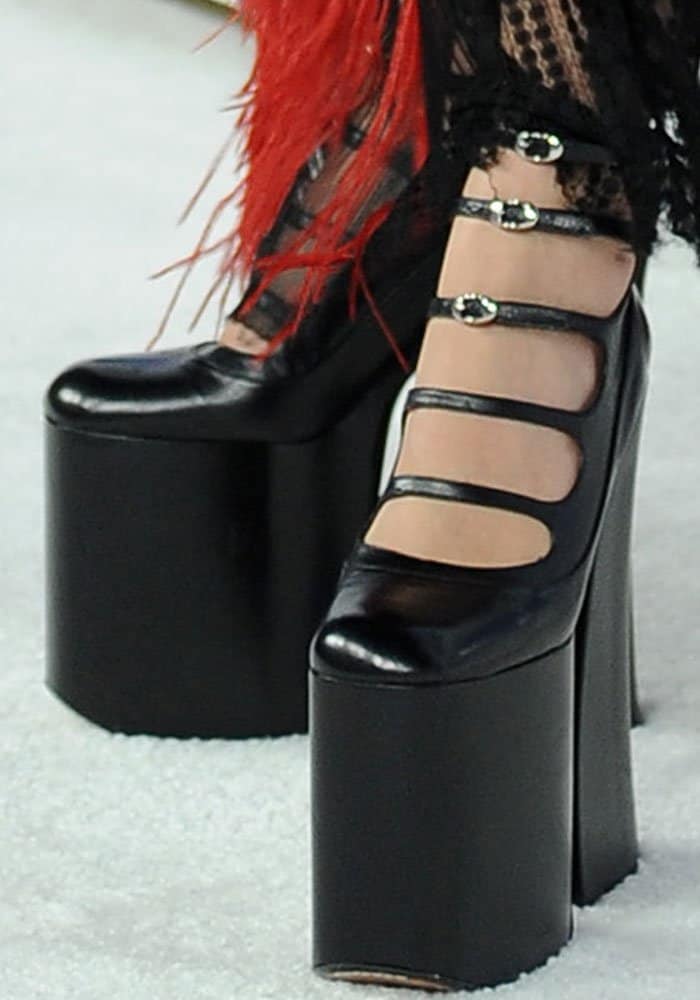 Rita Ora towers in dramatic Marc Jacobs "Lili" platform heels featuring bold multiple straps and sky-high block soles