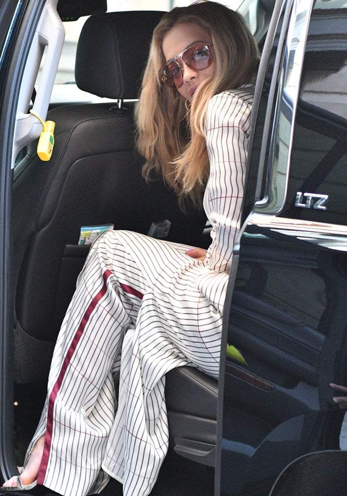 Rita keeps her eyes covered with oversized sunglasses as she sits in her car