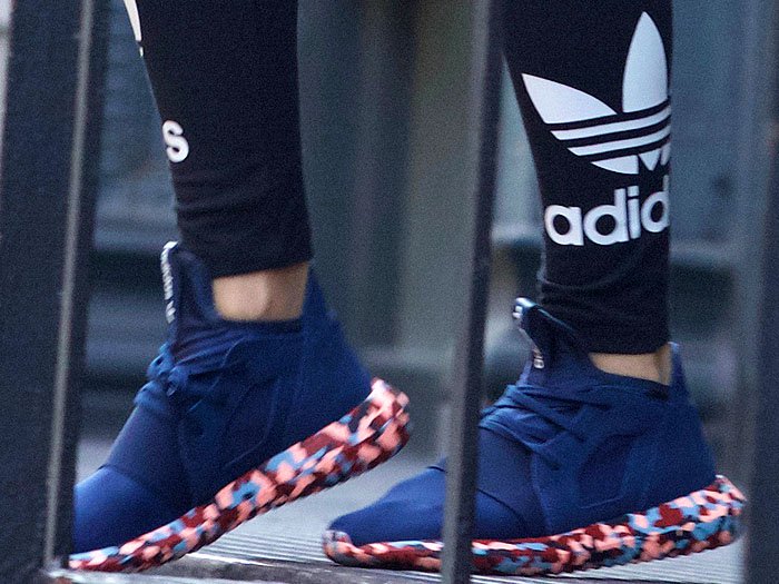 Rita Ora wearing navy Adidas Tubular Defiant Color Paint Pack sneakers in New York City