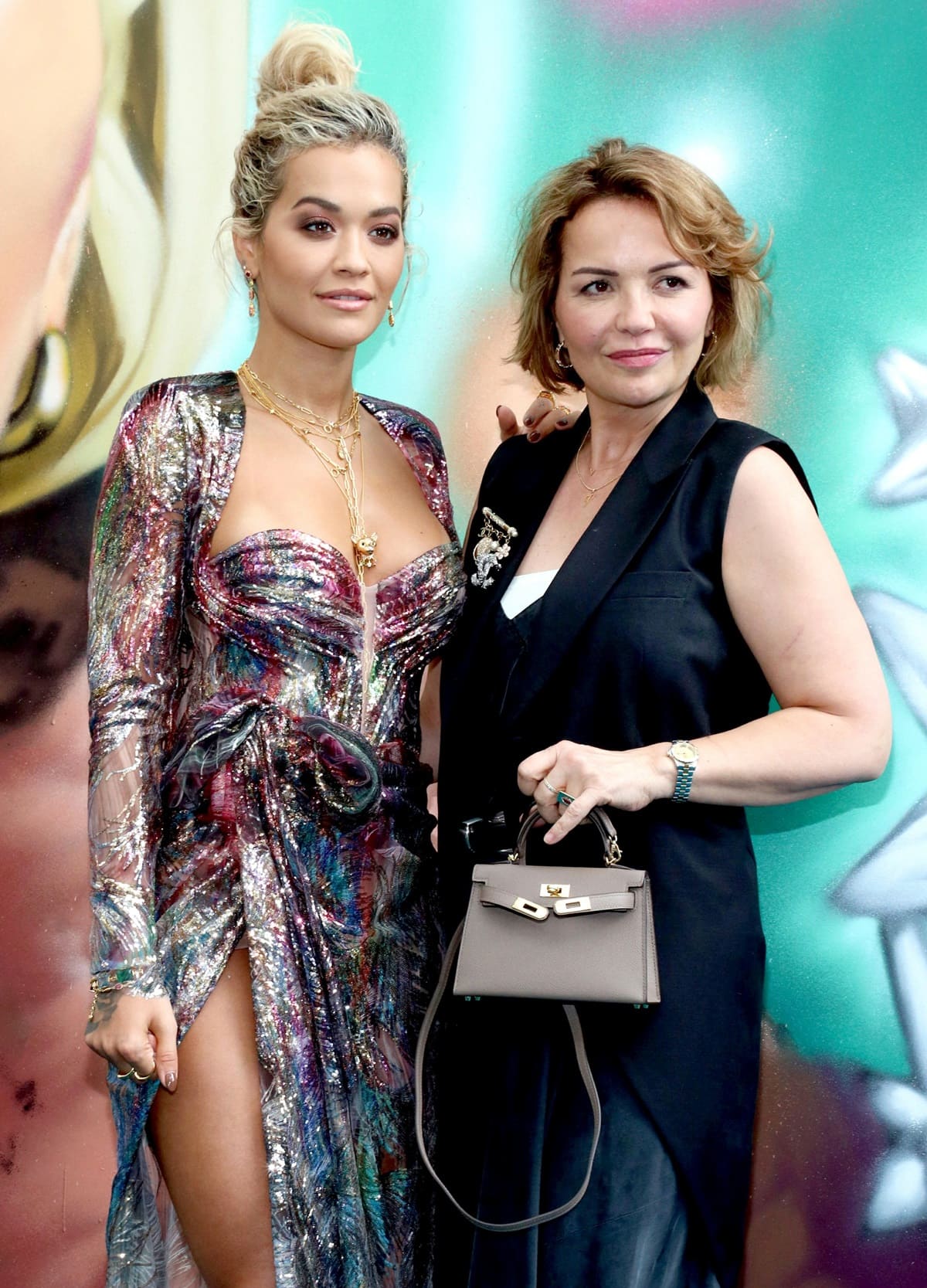 Rita Ora stuns in a metallic, thigh-slit gown alongside her mother, Vera Sahatçiu, a Kosovo-born psychiatrist, at a red carpet event