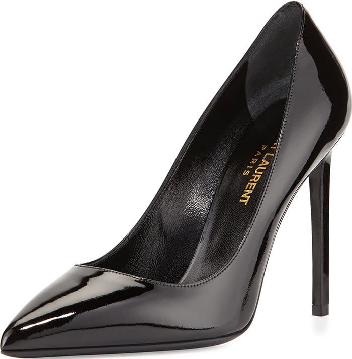 Black patent Saint Laurent “Paris” pumps showcase a razor-sharp pointed toe and slender stiletto heel, originally retailing for $595