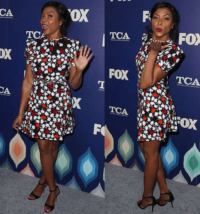 Taraji P. Henson playfully strikes a pose, showing off her toned legs and completing her look with black strappy heels that add a touch of elegance to her flirty floral dress