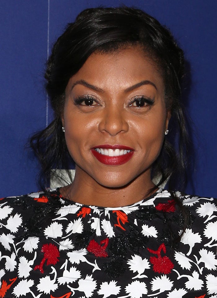 Taraji P. Henson completed her look with a chic braided updo, shimmering gold eyeshadow, and bold red lipstick while keeping her accessories minimal with elegant diamond stud earrings