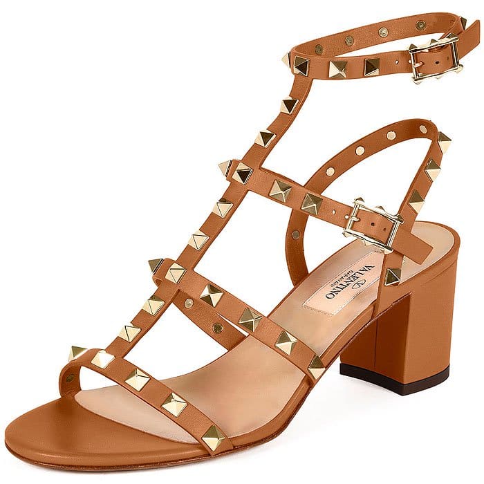 Valentino’s “Rockstud” leather City sandals in light cuir combine signature pyramid studs with a structured T-strap silhouette and sturdy block heel, delivering a polished, city-ready take on the house’s iconic hardware (originally retailing for $1,045)