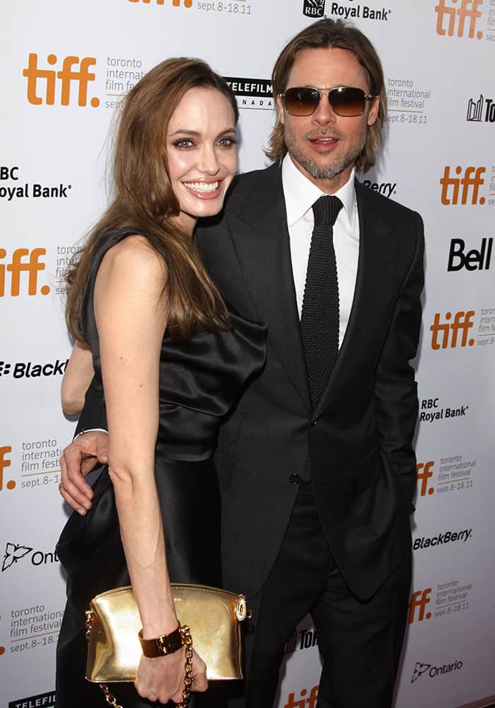 Kinky in a black Vivienne Westwood "Savannah" satin gown and black Stuart Weitzman pumps