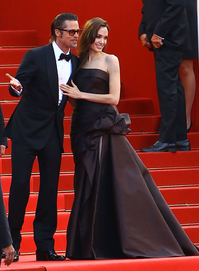 The couple slays the Cannes red carpet in 2011, with Angelina in a chocolate Atelier Versace strapless silk gown and matching Salvatore Ferragamo satin peep-toes at "The Tree of Life" premiere