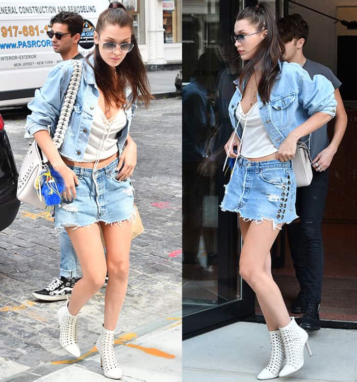 Bella Hadid completed her edgy double-denim ensemble with a white Fendi shoulder bag detailed with black whipstitch trim and playful blue-and-yellow fur keychain charms