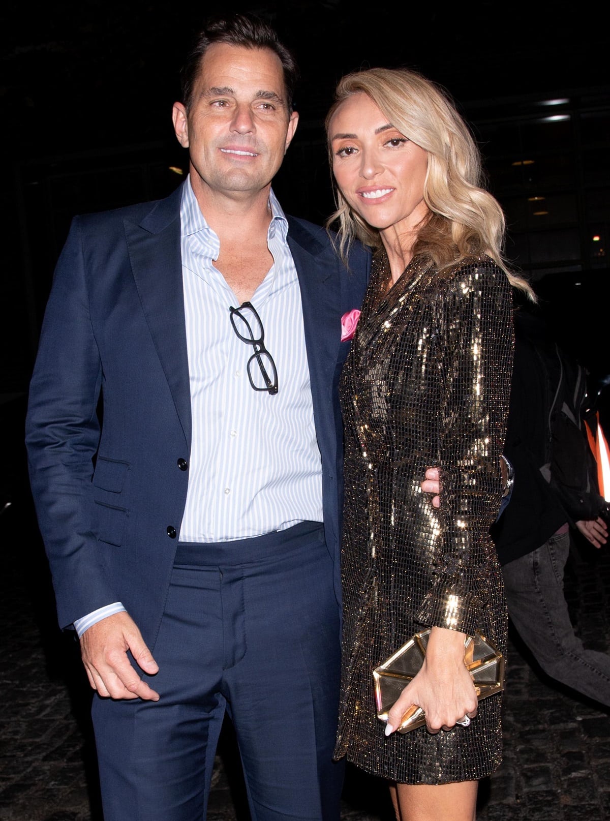 Bill and Giuliana Rancic stepped out in style to celebrate the grand opening of RPM Italian at The Forum Shops at Caesars on May 14, 2022, in Las Vegas, with Giuliana dazzling in a glittering metallic blazer dress and gold clutch