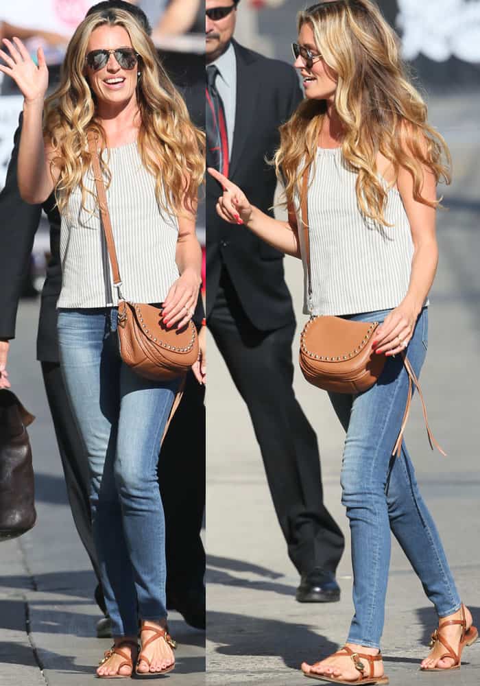 Cat Deeley donned a sleeveless striped top paired with denim jeans, completing her ensemble with aviator sunglasses, a studded leather shoulder bag, and a classic pair of Mulberry "Bayswater" sandals