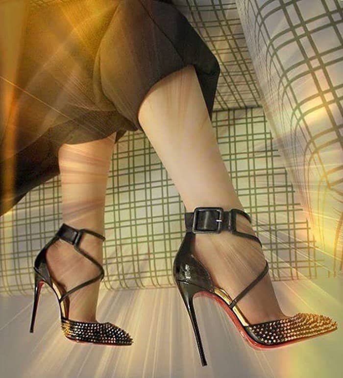 Christian Louboutin 'Suzanna' pumps dazzle with spiked detailing, crisscross straps, and the iconic red sole, making them a bold yet elegant statement