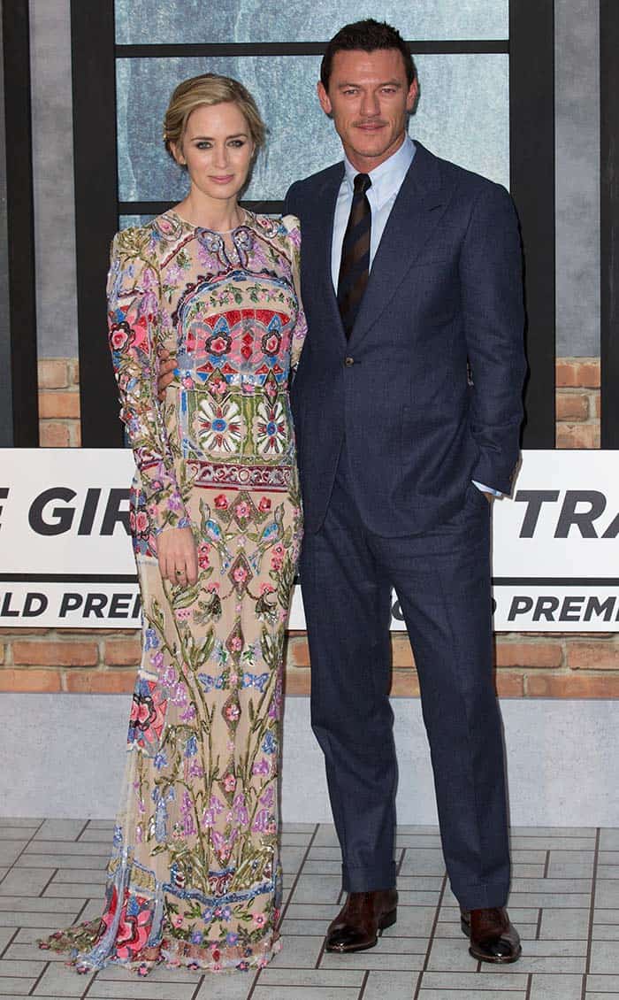 Emily Blunt dazzles in a floor-length, floral-embroidered Alexander McQueen gown alongside co-star Luke Evans in a sharp navy suit