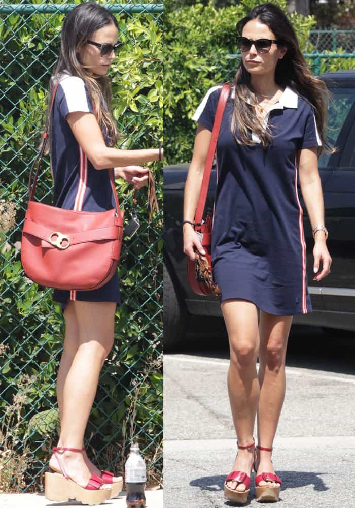 Jordana Brewster steps out in a sporty navy Tory Sport dress, pairing it with a red Tory Burch "Gemini Link" shoulder bag and Stella McCartney platform wedges that add bold height to her look