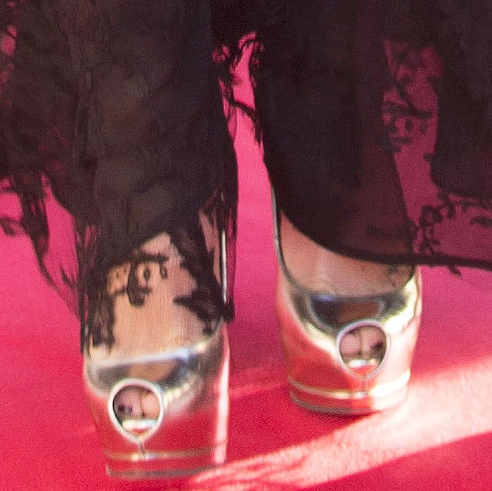 A closer look at Hudson’s metallic Giuseppe Zanotti “Sharon” platform peep-toe pumps, their sculptural heels catching the light beneath the gown’s lace hem