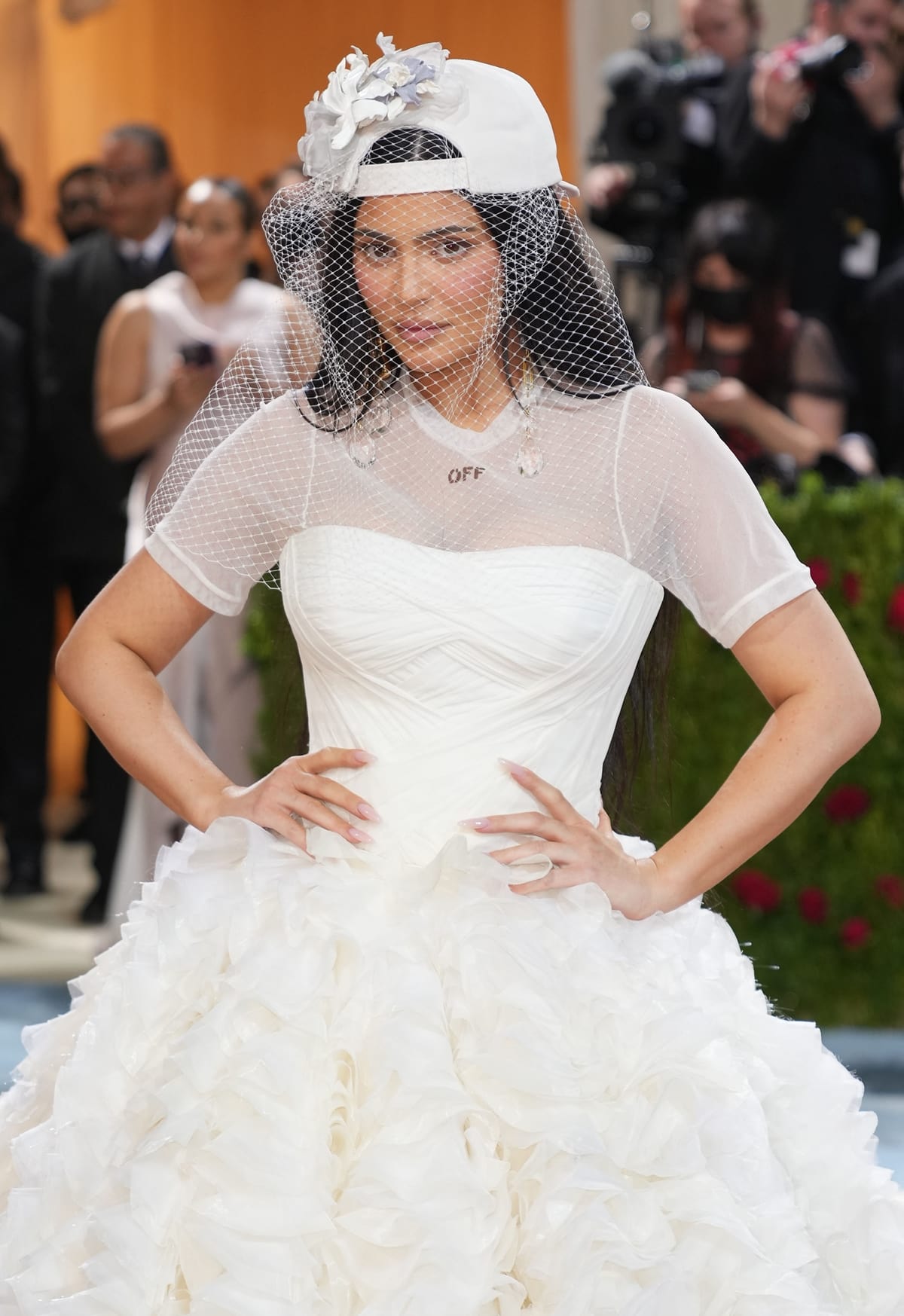 Kylie Jenner styled her voluminous Off-White wedding gown with a sheer mesh T-shirt overlay featuring the brand’s logo, blending streetwear edge with bridal elegance