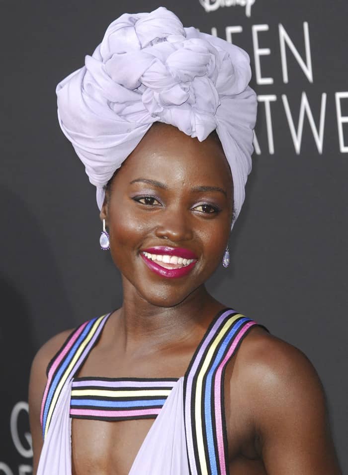 Lupita Nyong'o complemented her lavender Elie Saab gown with a sculptural matching headwrap and pastel-striped straps
