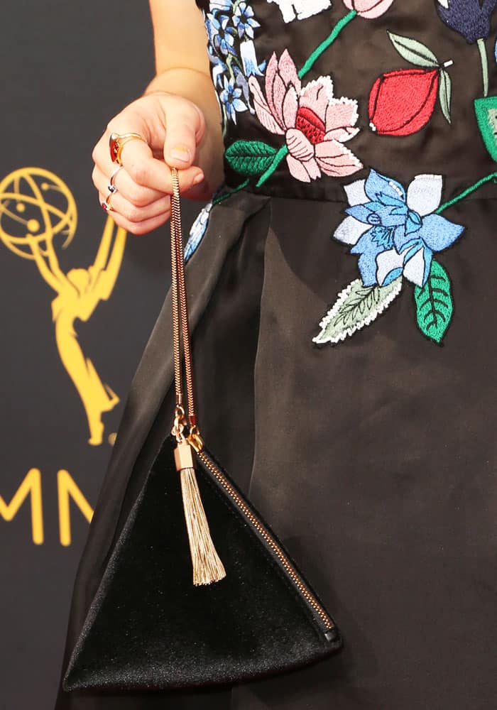 Maisie Williams shows off details of her custom-made Markus Lupfer dress and rectangular pouch from Charles Keith