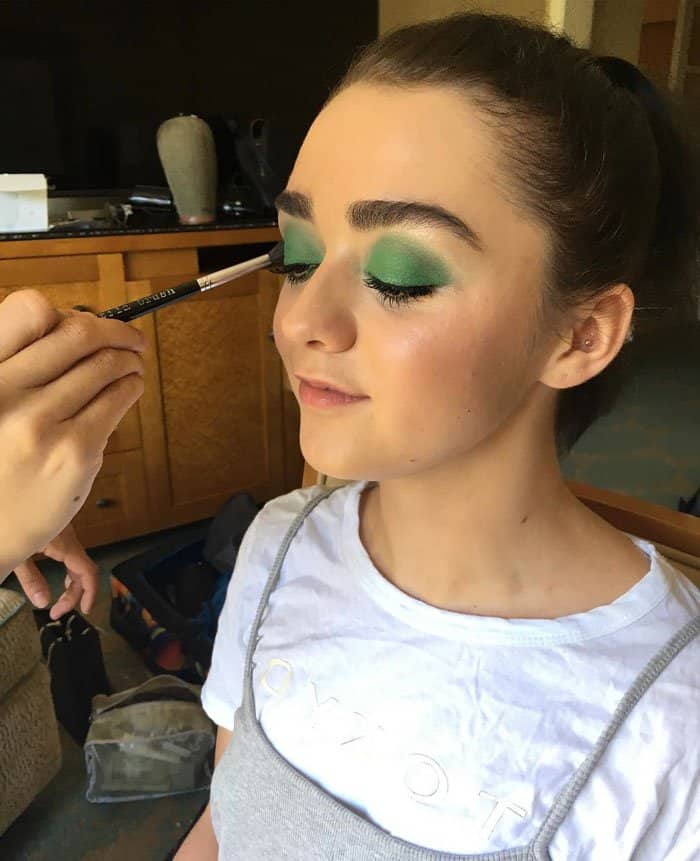 Maisie Williams gets her bold green eyeshadow applied ahead of the Emmys, proving that daring eye makeup can be both playful and sophisticated when paired with a fresh, glowing complexion