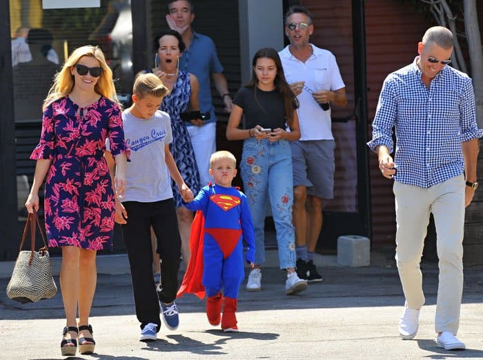 Reese Witherspoon steps out with husband Jim Toth and her sons Deacon and Tennessee—who adorably wore a Superman costume—after Sunday church in Brentwood