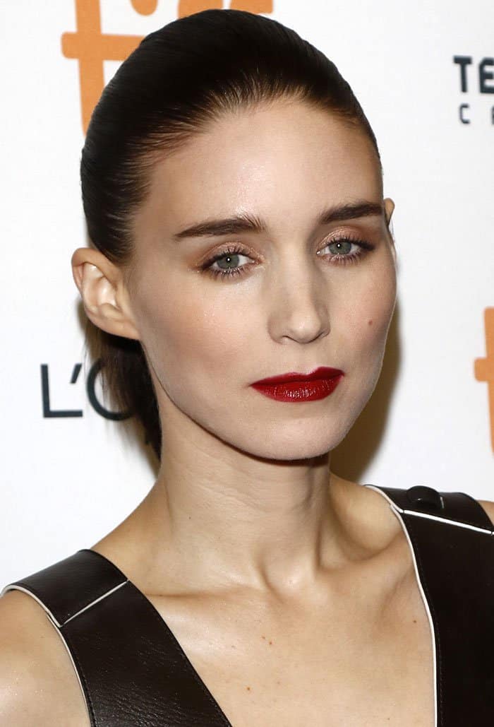 Rooney Mara's dark hair was smoothly pulled back into a ponytail, complemented by a striking deep red lipstick