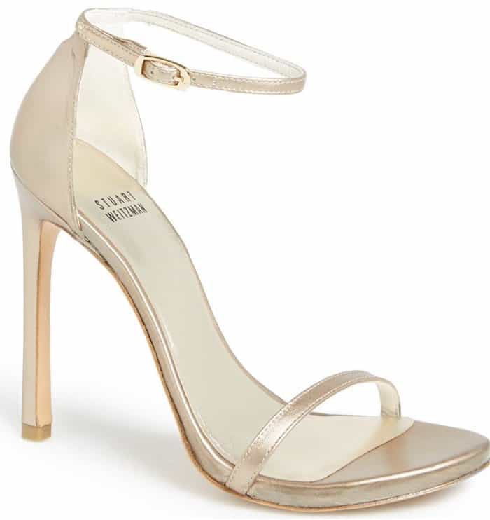 The Stuart Weitzman “Nudist” sandal became a red-carpet staple thanks to its minimalist single-strap design and sky-high stiletto heel, a barely-there silhouette that elongates the legs while letting gowns take center stage