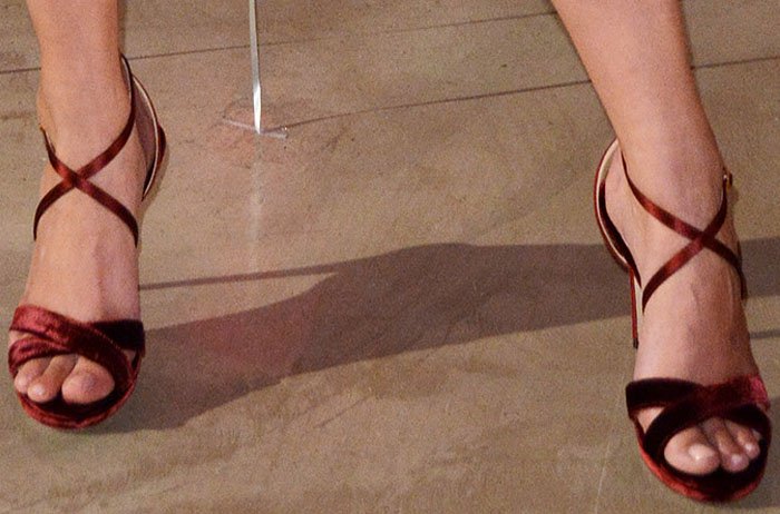 Taylor Hill showed off her flawless pedicure in burgundy velvet Jimmy Choo “Lola” sandals, featuring elegant crisscross straps and a high stiletto heel