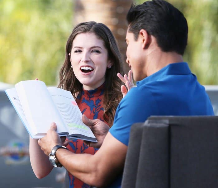 Anna Kendrick reacts with a laugh as Mario Lopez reads from her recently published book, "Scrappy Little Nobody"