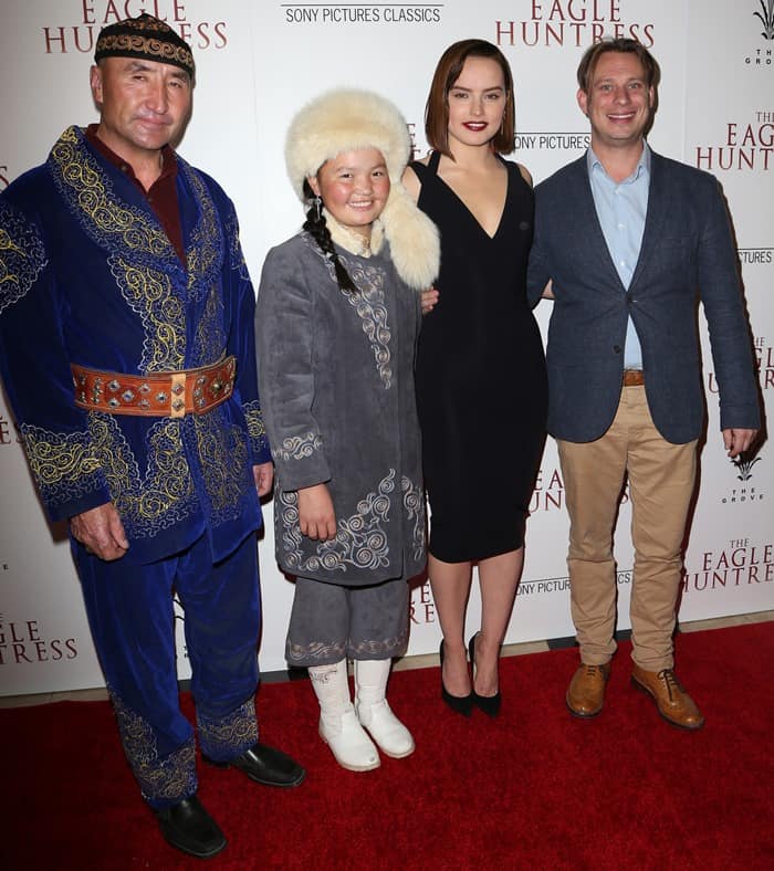 Daisy Ridley posing with director Otto Bell and subjects of the documentary film Nurgaiv Rys and Aisholpan Nurgaiv