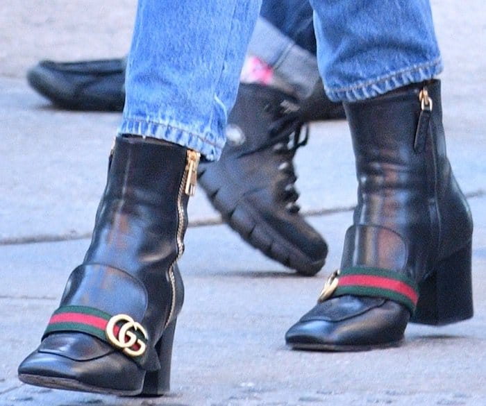 Dakota Johnson steps out in style, showing off her chic Gucci Peyton leather mid-heel ankle boots, featuring the signature double-G emblem