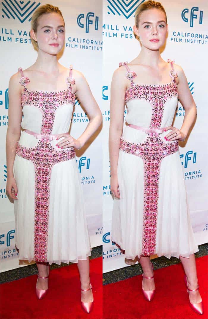 Elle Fanning wore a stunning Prada dress adorned with pink beads and bows, complementing her Elle Woods-inspired look with pink Mary Jane pumps and accessorizing with exquisite pink Tiffany Co. jewelry