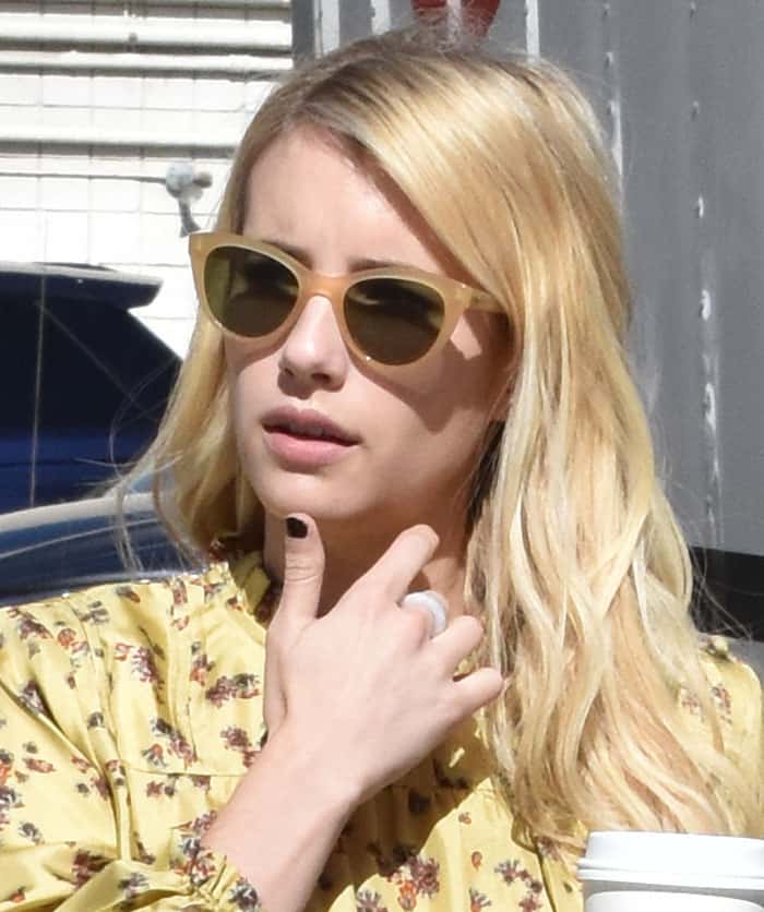 Emma Roberts shows off her casual glam with tousled blonde waves, a black manicure, and a simple silver ring