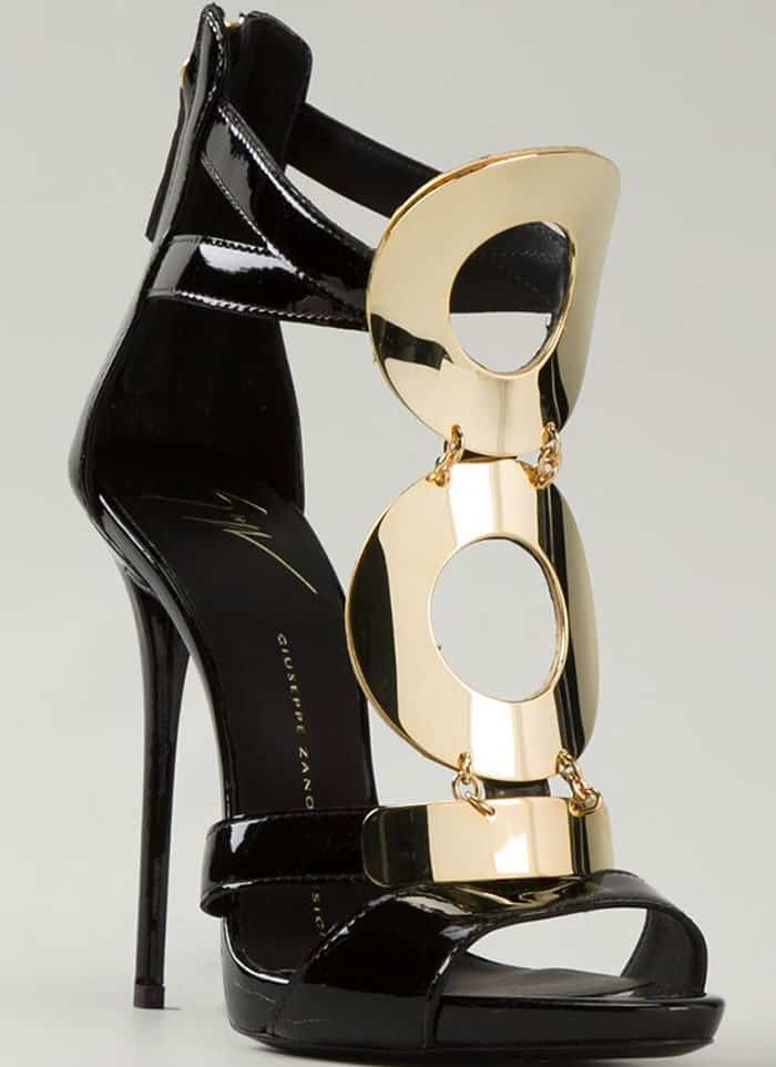 Giuseppe Zanotti’s black patent sandals featuring oversized gold geometric hardware and a towering stiletto heel
