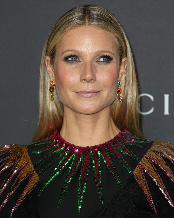 Gwyneth Paltrow pairs her sleek, straight hair with colorful dangling earrings