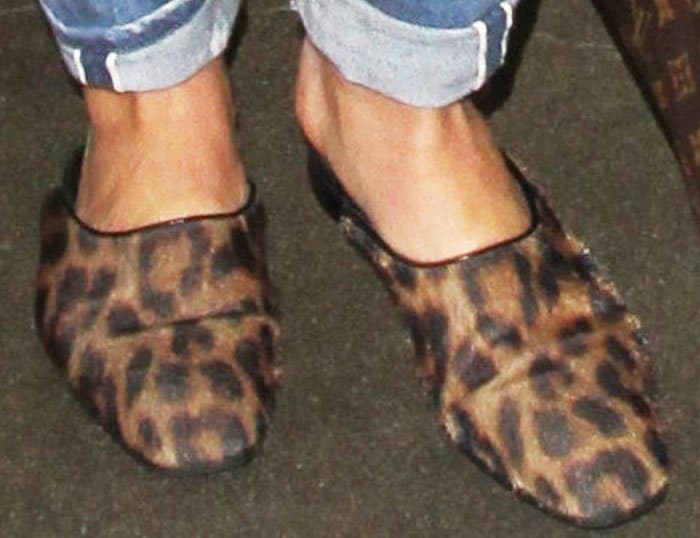 Hilary Duff's leopard-print Stella McCartney "Suffolk" slides brought a playful designer touch to her airport outfit while prioritizing the comfort needed for a long travel day