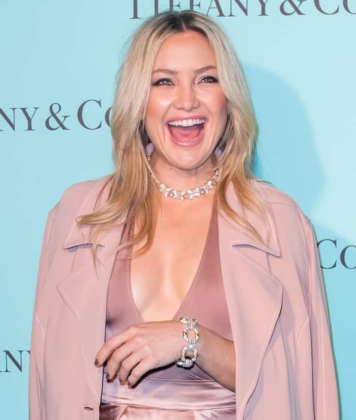 Kate Hudson radiates joy in a blush-toned ensemble, accessorized with dazzling Tiffany Co. jewelry at the Beverly Hills store celebration