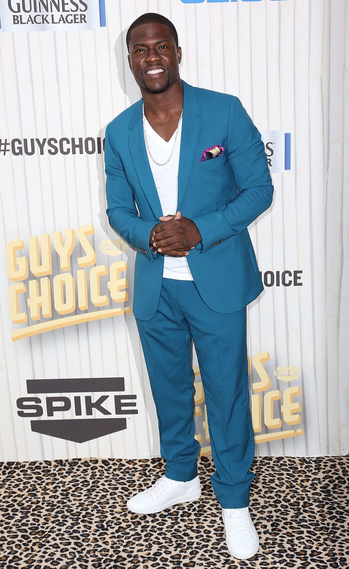 Kevin Hart rocks a vibrant teal suit paired with casual white sneakers, adding a fresh and stylish flair to his look at the Spike Guys' Choice Awards