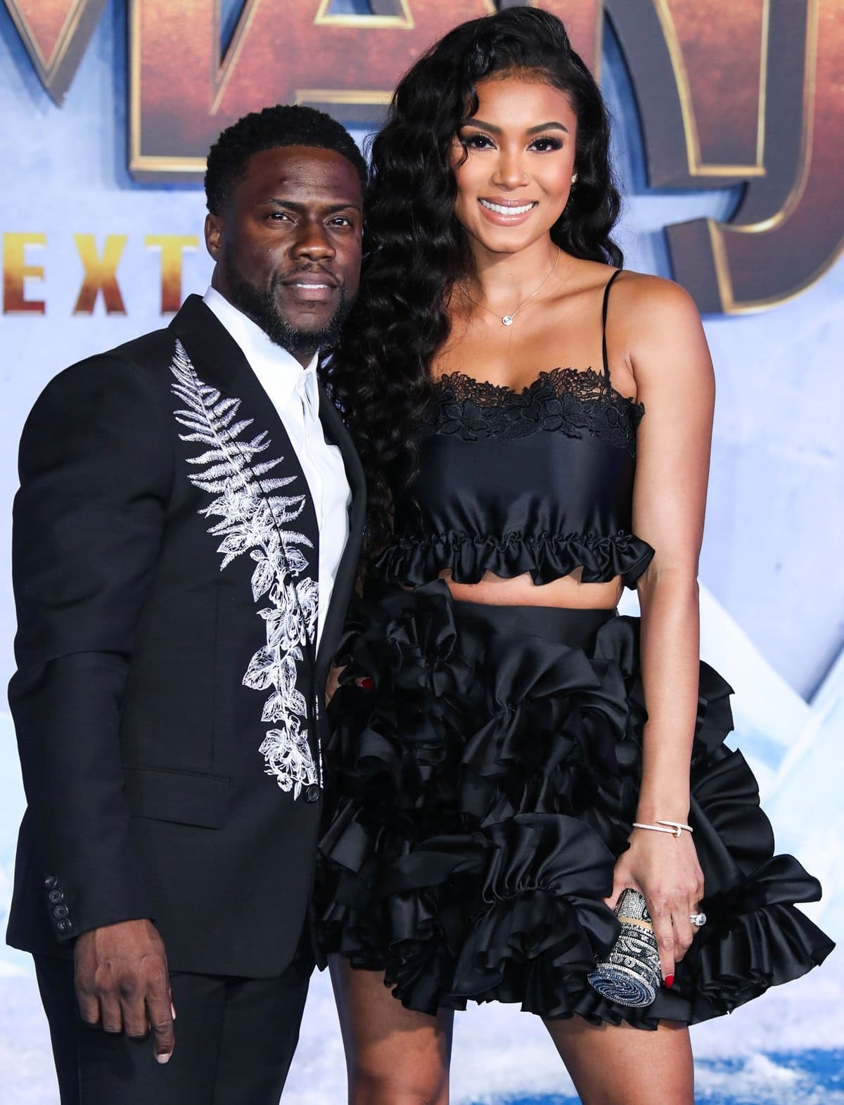 Kevin Hart and his wife, Eniko Parrish, showcase their stylish black outfits at the Jumanji: The Next Level premiere, with their noticeable height difference adding to their striking red carpet presence